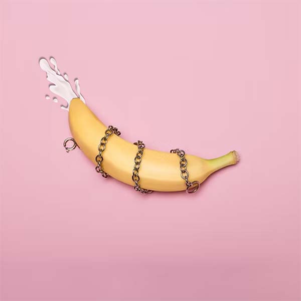 picture of a banana wrapped in chains oozing milk