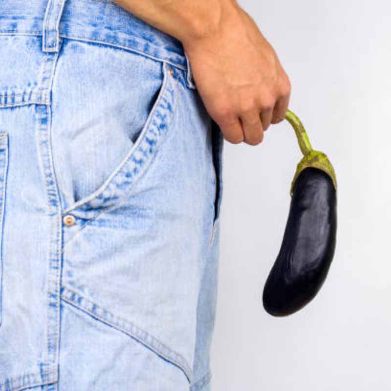 picture of a man holding an eggplant in front of his crotch