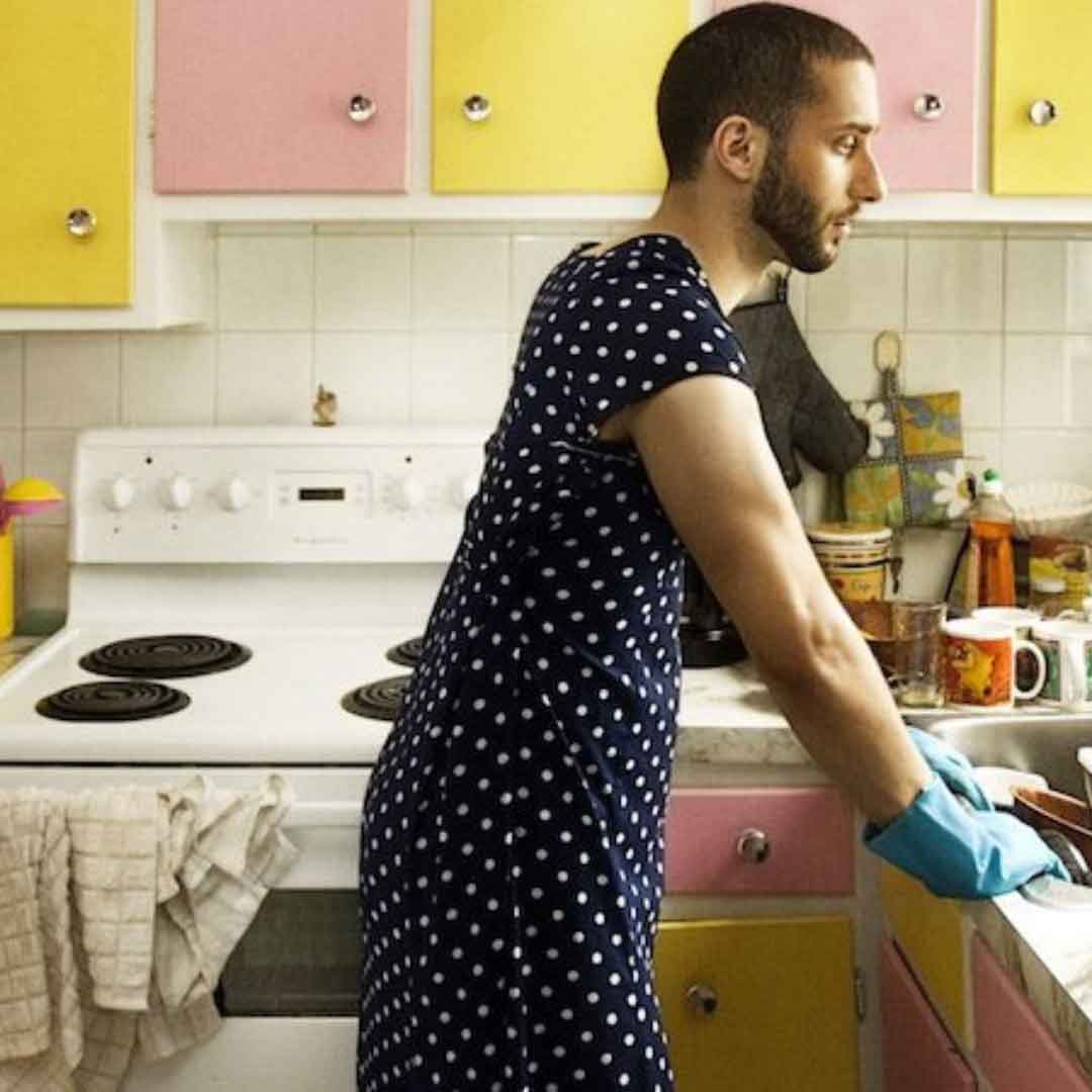 picture of an emasculated man cleaning the kitchen