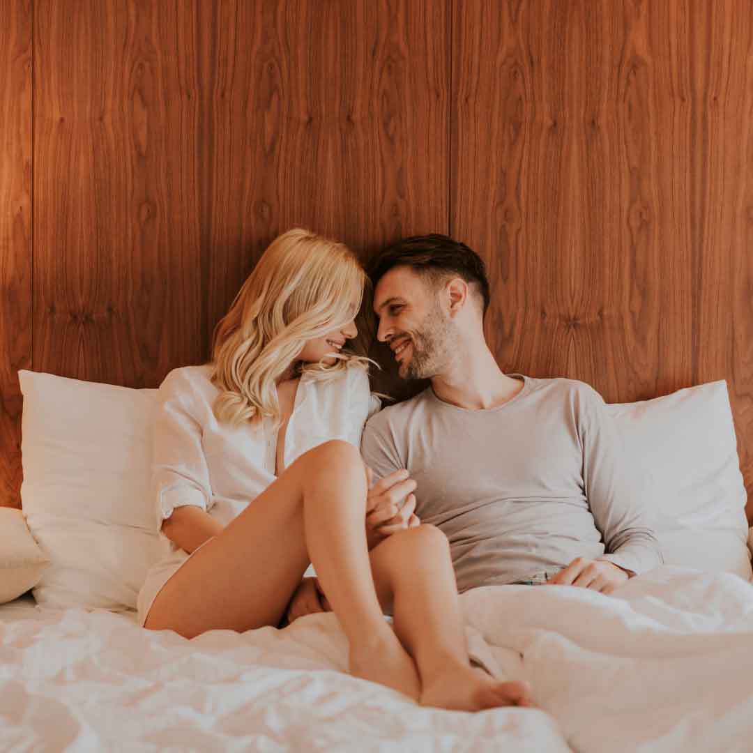 a couple in bed feeling a deeper connection 