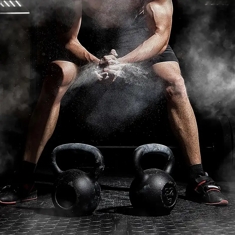 picture of a man manspreading with kettlebells symbolizing balls stretching